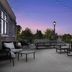 Hilton Garden Inn Cedar Falls rooftop terrace with lounge seating and string lights at dusk
