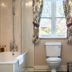 Manor Farm B&B in Marlborough bathroom with bathtub, shower, toilet and window with patterned curtains
