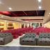 Hotel Grand Marian in Ludhiana banquet hall with rows of red chairs and patterned sofas