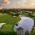 The Ritz-Carlton Orlando Grande Lakes with golf course, water feature and skyline at sunset