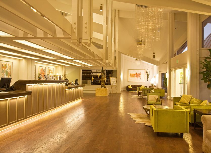 Ashland Hills Hotel & Suites in Ashland lobby with high ceilings, wood floors, and lounge seating