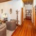 La Plume Boutique Hotel & Spa Oudtshoorn lounge with leather sofa, armchairs and polished wood flooring