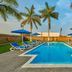 City Express by Marriott Lazaro Cardenas pool with blue loungers, umbrellas and palm trees in Lazaro Cardenas