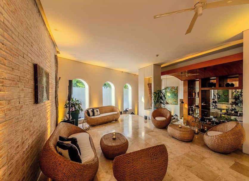 Hotel Boutique Bovedas de Santa Clara By Accor in Cartagena lobby with woven lounge chairs and arched windows