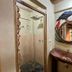 Salkantay Hostel Chaullay bathroom with rustic wood sink, mirror, shower and bird wall decor in Santa Teresa