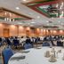 Quality Hotel Conference Center Cincinnati Blue Ash banquet room with round tables and blue chairs in Cincinnati