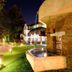 Caro Horoscop Hotel in Bucharest with illuminated garden pathway and courtyard fountain at night