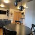 Media Luna Guesthouse in Seydisfjordur living area with round table, sofa, wall TV and kitchen nook