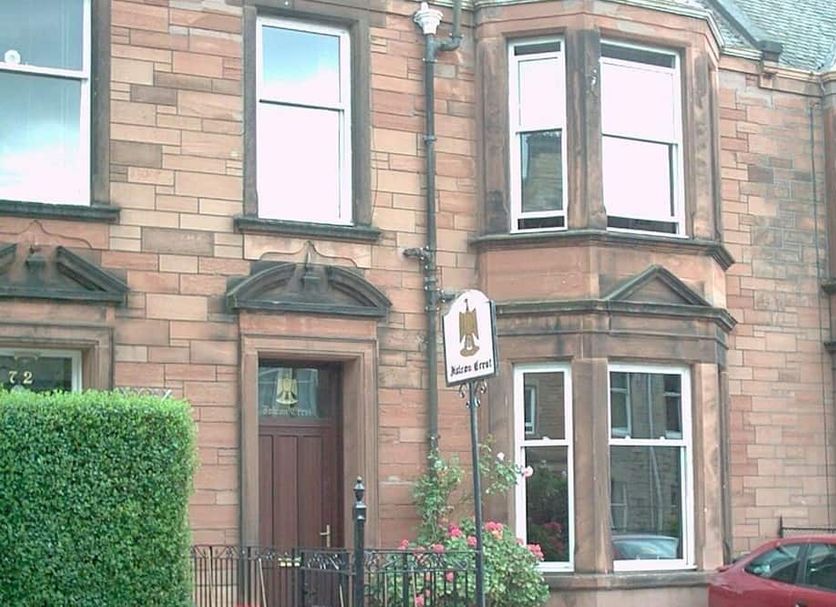 Falcon Crest Guest House in Edinburgh, stone-front hotel exterior with bay windows and a parked car