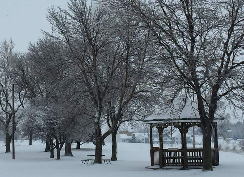 Crest Country Inn in Williamsburg with snow-covered grounds, bare trees, and a gazebo