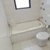 The Citi Inn, Jamshedpur bathroom with bathtub, toilet, and tiled walls