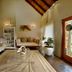 Kwafubesi Tented Safari Camp lounge in Rooiberg with seating, rug, high thatched ceiling and garden view