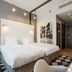 Qubus Hotel Bydgoszcz guest room with two twin beds, modern lighting, and checkered rug in Bydgoszcz