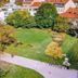 Urban Boutique Hotel Center in Ljubljana overlooking a green park with trees and a walking path