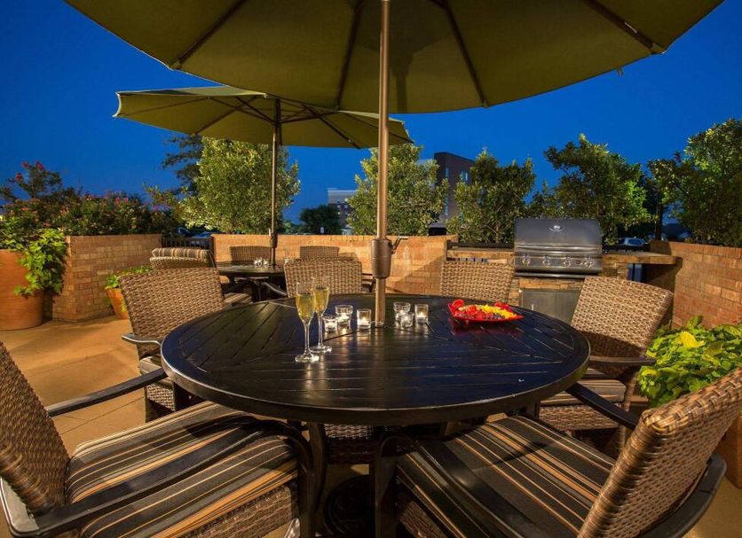 TownePlace Suites by Marriott Dallas Lewisville outdoor patio with table, chairs and umbrellas