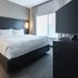 Residence Inn by Marriott Wilkes-Barre Arena guest room with king bed, bedside lamps, TV, and window