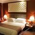 Nenjiang Hotel, Qiqihar: double bed room with upholstered headboard, bedside lamps, and dark curtains