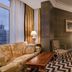 Relais & Châteaux Heritage Hotel Madrid guest room with city view, sofa, bed and patterned rug