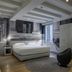 Lords of Verona Luxury Apartments room in Verona with bed, mural wall, window and modern chair