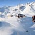 Das Alpenhaus Gasteinertal in Bad Hofgastein with a ski gondola over snowy alpine mountains