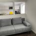 Weserlounge Hotel Garni in Hessisch Oldendorf, gray sofa seating area with kitchenette pass-through