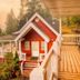 Hearthstone Elegant Lodge by the River in Kamiah, red cabin with porch, deck, and forest river views