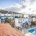 Belvedere Village in Agia Pelagia with white-and-blue buildings, pools, sun loungers and hillside views