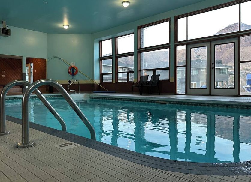 Indoor pool at Kings Motor Inn in Kamloops with large windows and mountain views