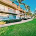 Riverwatch Apartments By Lowkl in Jensen Beach with palm trees and a lush green courtyard