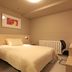 Century Star Urumqi Changjiang Road Hotel guest room with a double bed, desk, and chair in Ürümqi