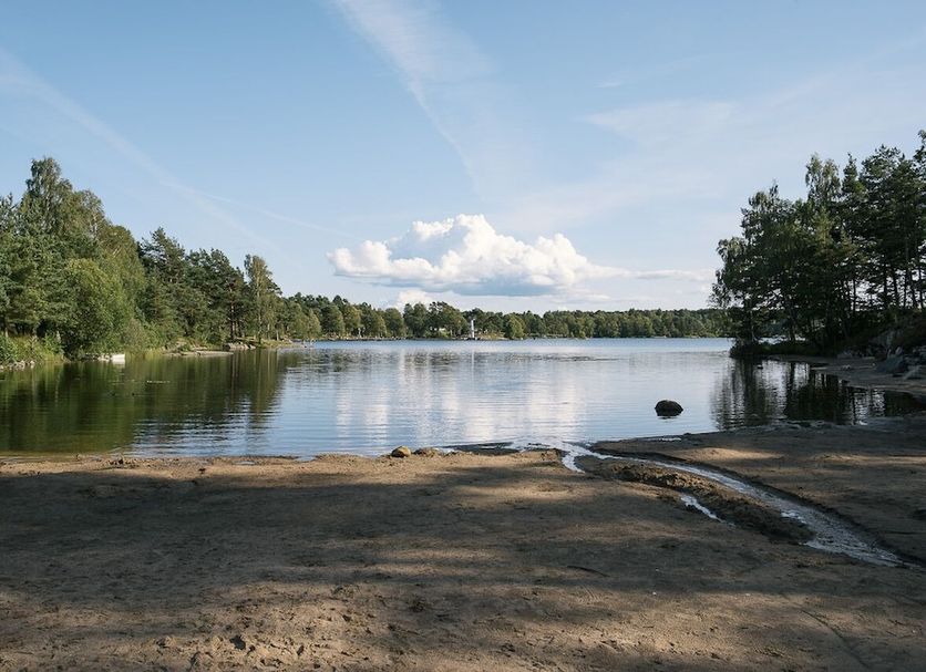Partille Vandrarhem in Partille with a शांत lake view, sandy shore, and tree-lined banks