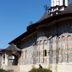 Casa Octavian in Suceviţa, exterior view of a historic painted church with a tall tower