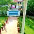 Achayans Homestay Mararikulam in Alappuzha with a garden path and blue front gate
