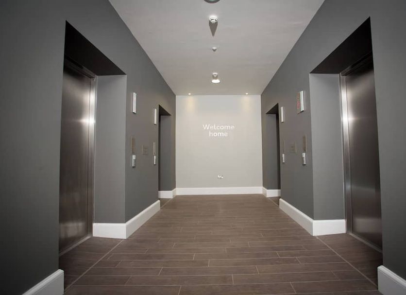Staybridge Suites Birmingham By IHG elevator lobby with gray walls and wood-look tile flooring