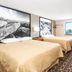 Super 8 by Wyndham Miles City guest room with two beds, desk and window view