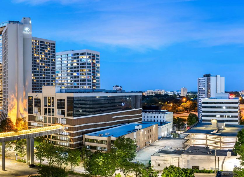 Hilton Atlanta in Atlanta skyline view with elevated walkway and city lights at dusk