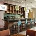 Home2 Suites by Hilton Orlando at FLAMINGO CROSSINGS Town Center breakfast bar and seating near large windows in Bay Lake