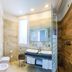 Hotel Panoramic, Caorle: modern bathroom with double sinks, walk-in shower and wood-paneled wall