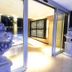 Residence Diamanterosso in Terni with ornate urn sculptures beside a modern glass-walled interior