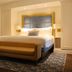 The Adelphi Hotel in Saratoga Springs guest room with king bed and upholstered bench