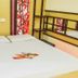 Hotel Sogo Quezon Avenue in Manila guest room with double bed, floral curtains, and open shelving