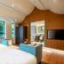 Guanyin Yiyuntai Hotel Chengdu guest room with twin beds, floor-to-ceiling windows, and lounge chairs