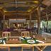 The Purist Villas & Spa Ubud open-air dining area with set table and lounge seating