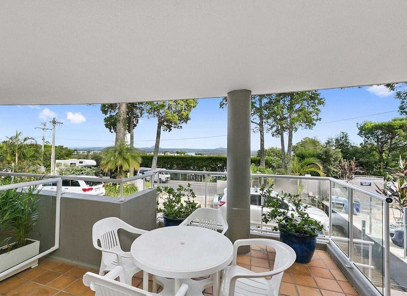 Private Apartments at Picture Point Noosa balcony with table, chairs and leafy Noosa Heads views