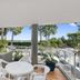 Private Apartments at Picture Point Noosa balcony with table, chairs and leafy Noosa Heads views