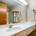 Quality Inn Rosebud Casino bathroom with vanity, mirror, towels, and toilet in Mission