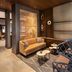 Hyatt Place South Reno lounge with tan sofa, patterned chairs and decorative railing in Reno