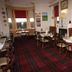 St Olaf Golf Hotel in Peterhead dining room with red tartan carpet, tables, chairs and chalkboard menu