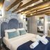 The Lift Boutique Hotel by Ridan Hotels in Lisbon, bedroom with carved headboard and exposed wood beams