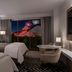 The Westin Anaheim Resort room with two beds and balcony view of the lit Disneyland fireworks in Anaheim